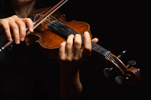 Musician playing violin in a private music studio at Sugar Land Art Center